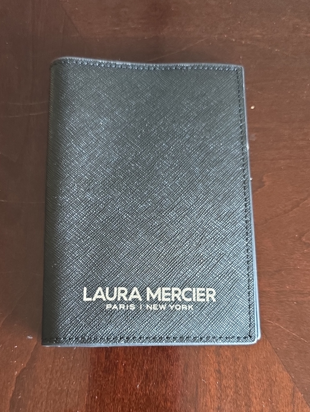 *NWOT*laura mercier Black textured Passport Holder with gold writing